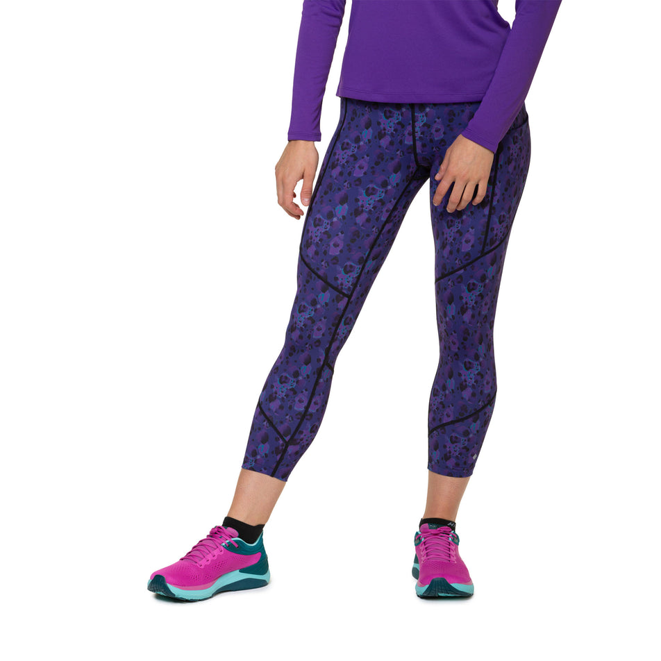 Front view of a model wearing the Ronhill Women's Tech Crop Tight in the Purple Leopard colourway. Model is also wearing shoes and a top. (8490052518050)