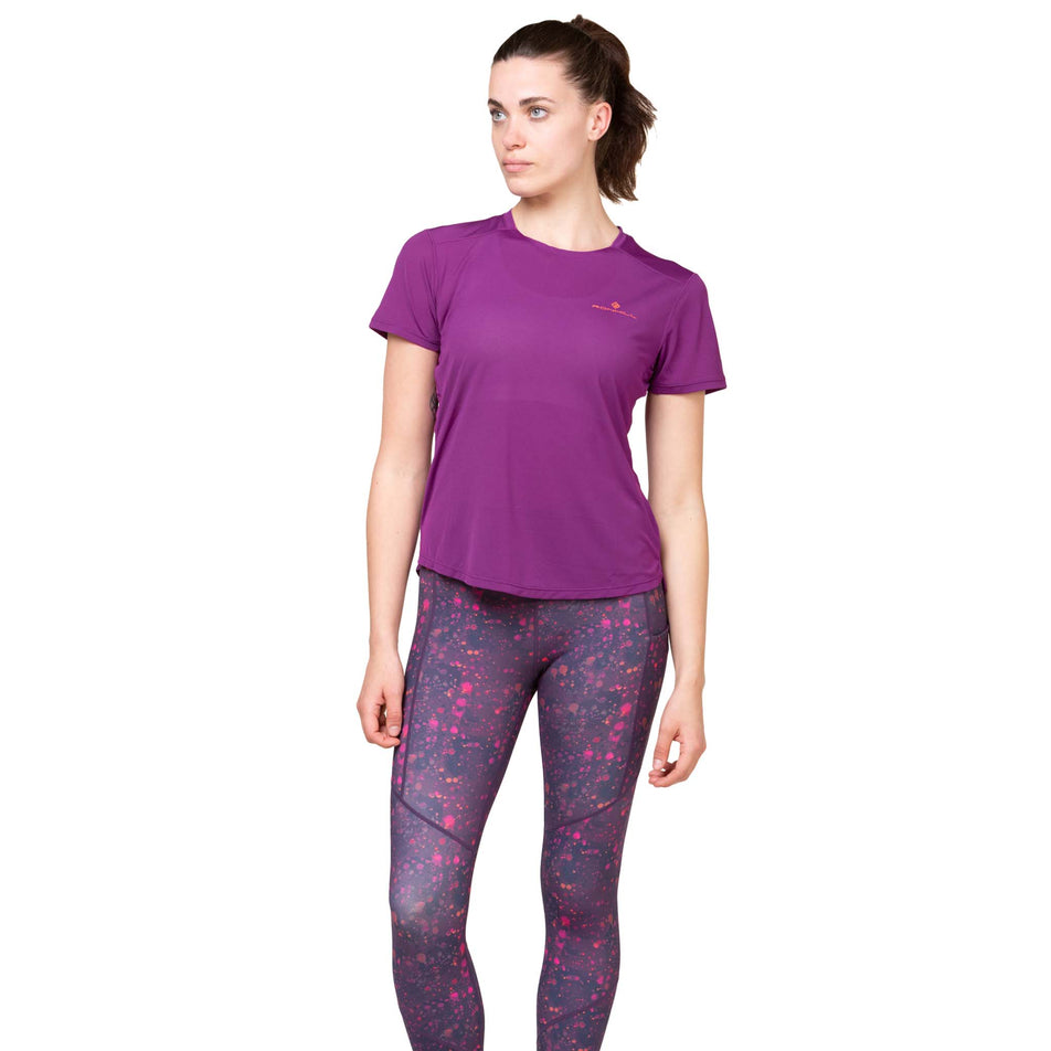 Front view of a model wearing the Ronhill Women's Tech Crop Tight in the Damson Raindrops colourway.(8564969472162)