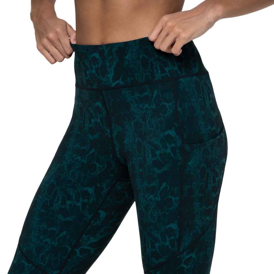 Front view of a model wearing the Ronhill Women's Tech Crop Tight in the Seaweed Medusa colourway. (8747588911266)