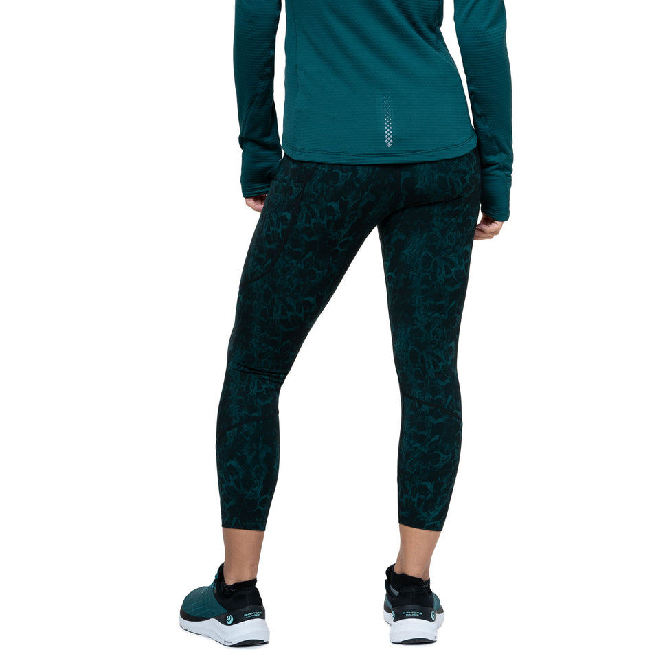 Back view of a model wearing the Ronhill Women's Tech Crop Tight in the Seaweed Medusa colourway. (8747588911266)