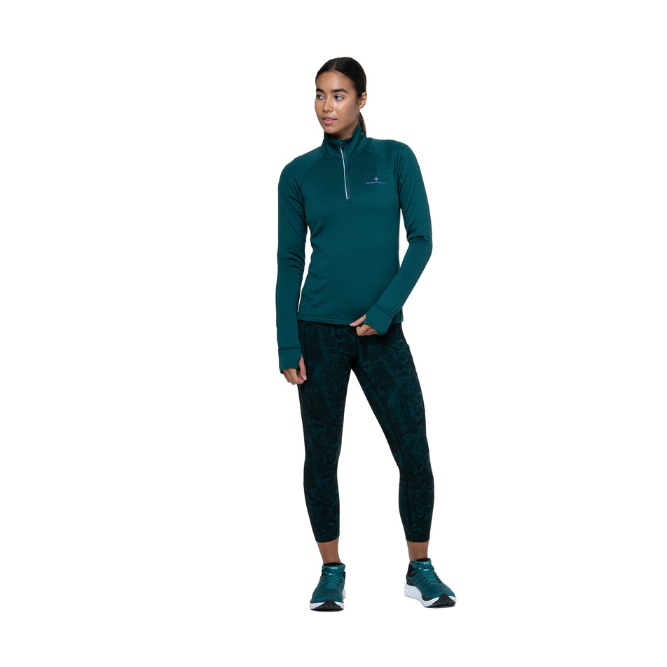 Front view of a model wearing the Ronhill Women's Tech Crop Tight in the Seaweed Medusa colourway. (8747588911266)