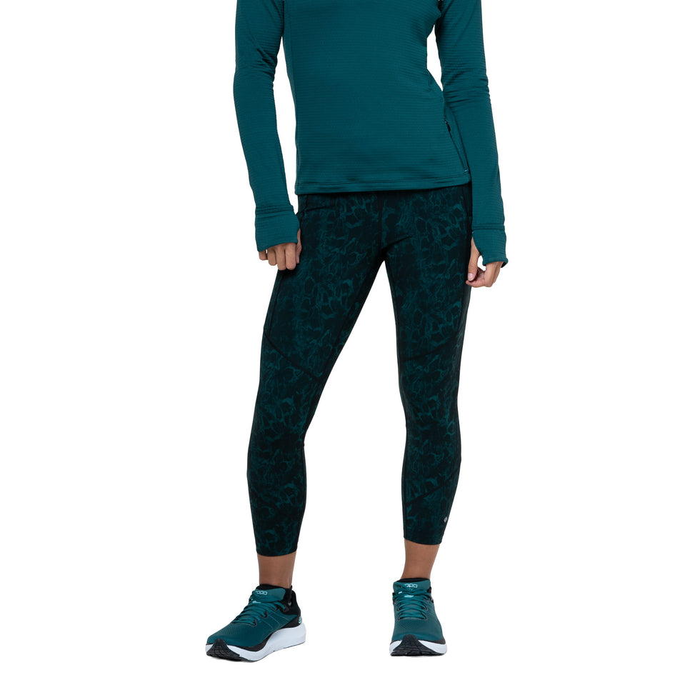 Front view of a model wearing the Ronhill Women's Tech Crop Tight in the Seaweed Medusa colourway. (8747588911266)