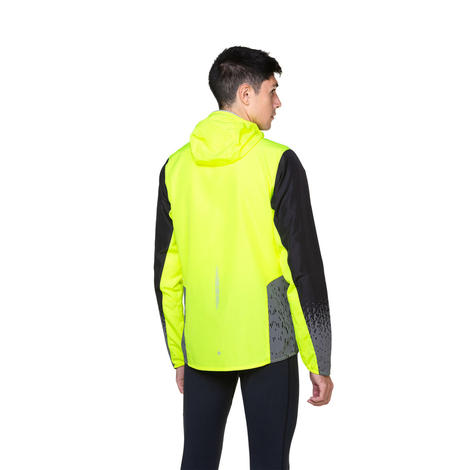 Back view of a model wearing a Ronhill Men's Tech Reflect Jacket in the Fluo Yellow/Black/Reflect colourway. Model is also wearing leggings. (8490189095074)