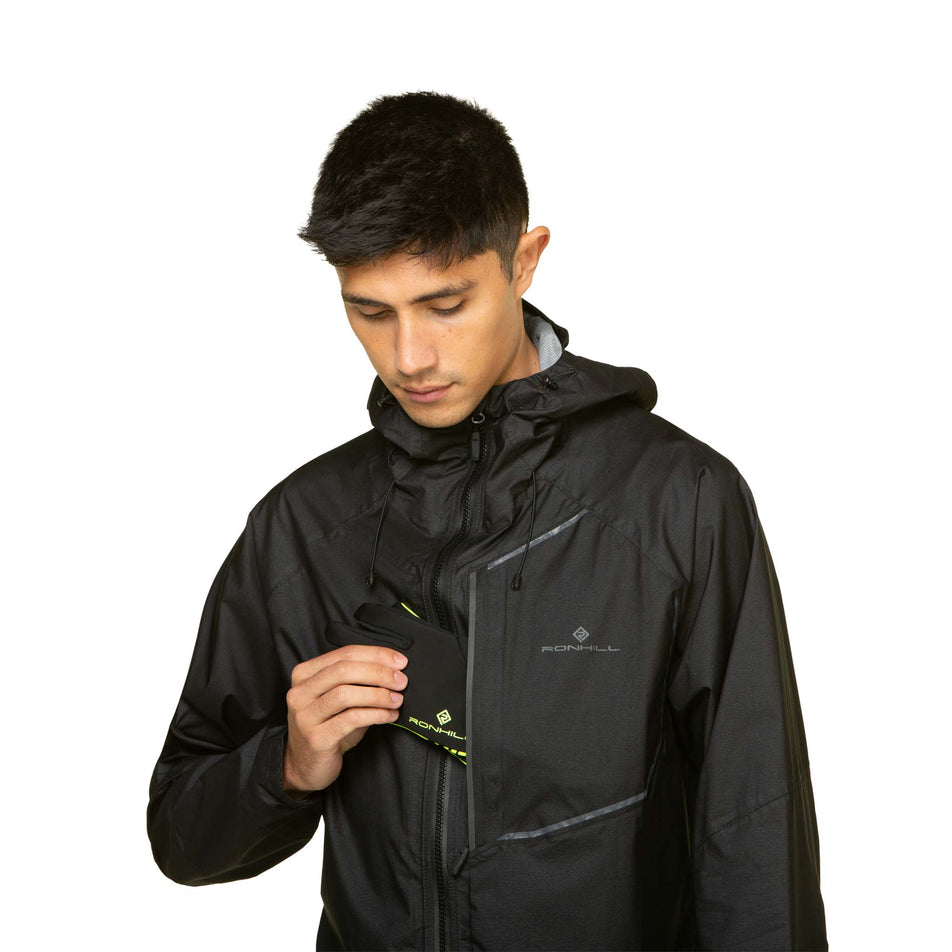 A model demonstrating that gloves can be stored in the chest pocket of the Ronhill Men's Tech Fortify Jacket. Jacket is being worn by the model. (8490250829986)