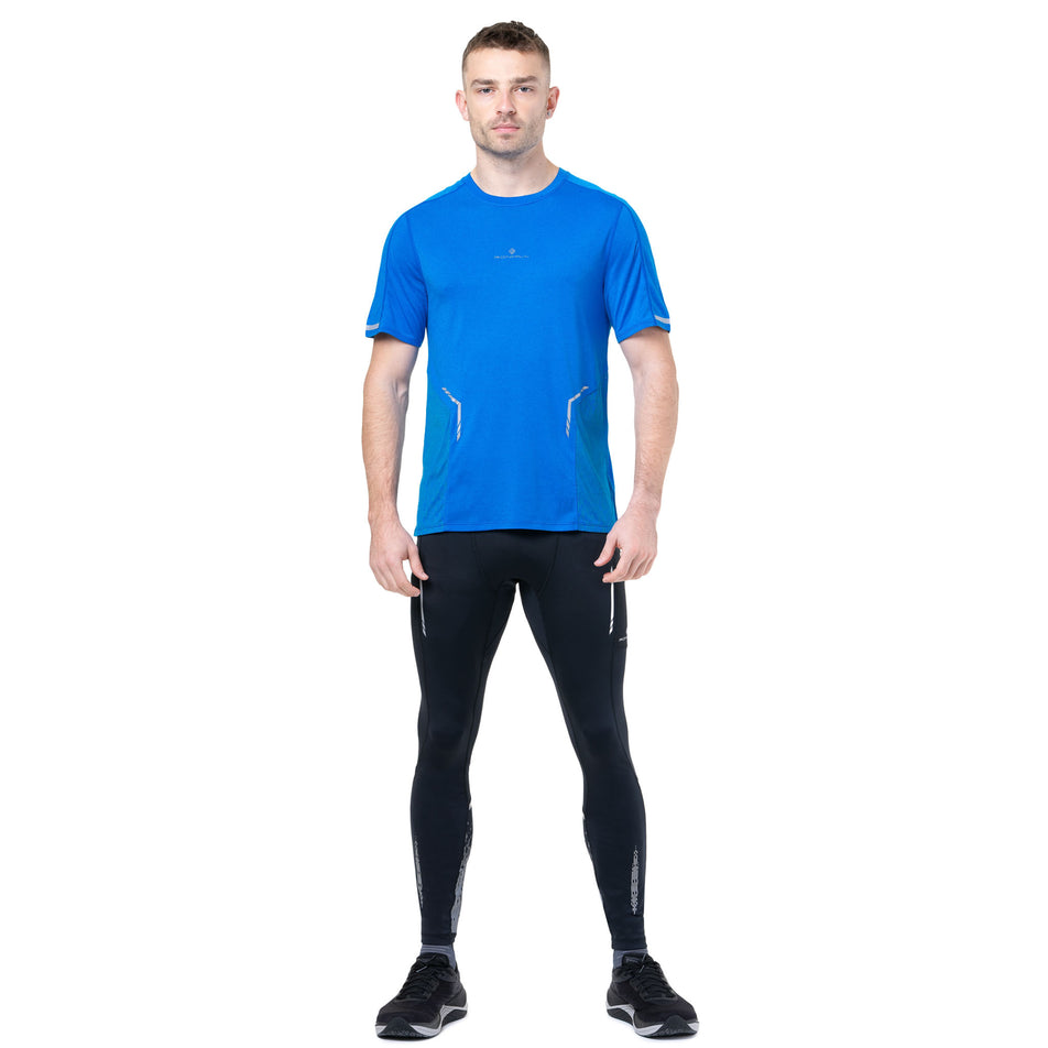 Back view of a model wearing the Ronhill Men's Tech Reflect S/S Tee in the ElecBlueMarl/Reflect colourway. (8747641831586)