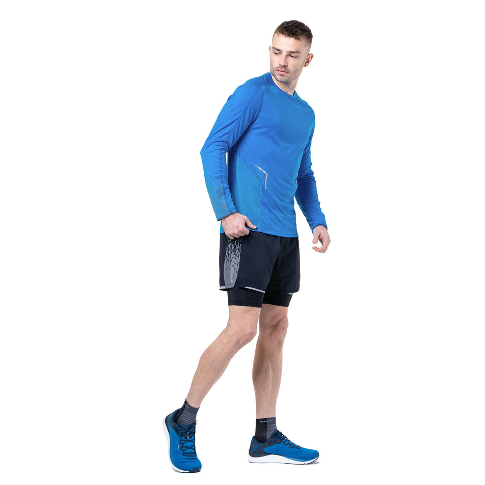 Front view of a model wearing the Ronhill Men's Tech Reflect L/S Tee in the ElecBlueMarl/Reflect colourway. (8747640520866)