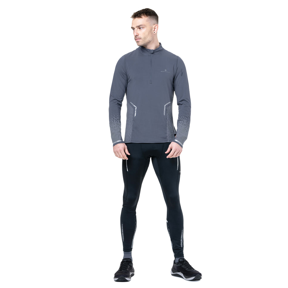 Front view of a model wearing the Ronhill Men's Tech Reflect 1/2 Zip in the Anchor/Reflect colourway. (8747638522018)