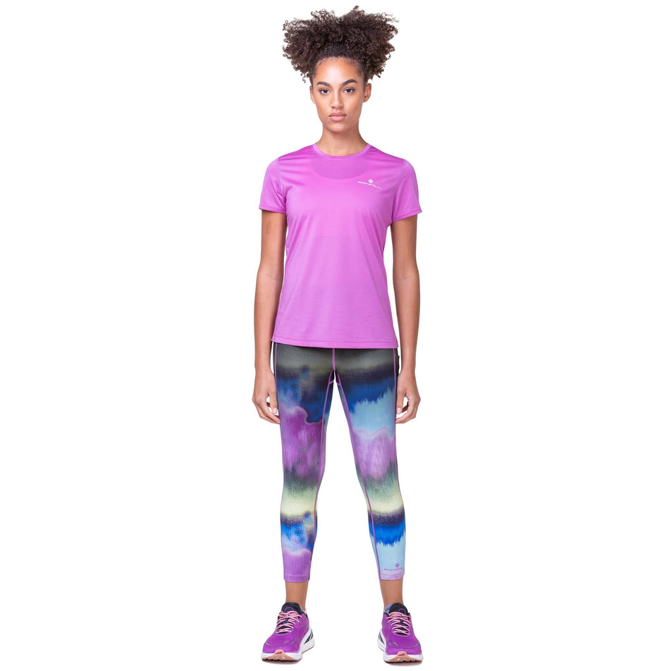 Front view of a model wearing the Ronhill Women's Tech Gradient Crop Tight in the Multi Mirage colourway. Model is also wearing a Ronhill running top and Altra running shoes. (8160844742818)
