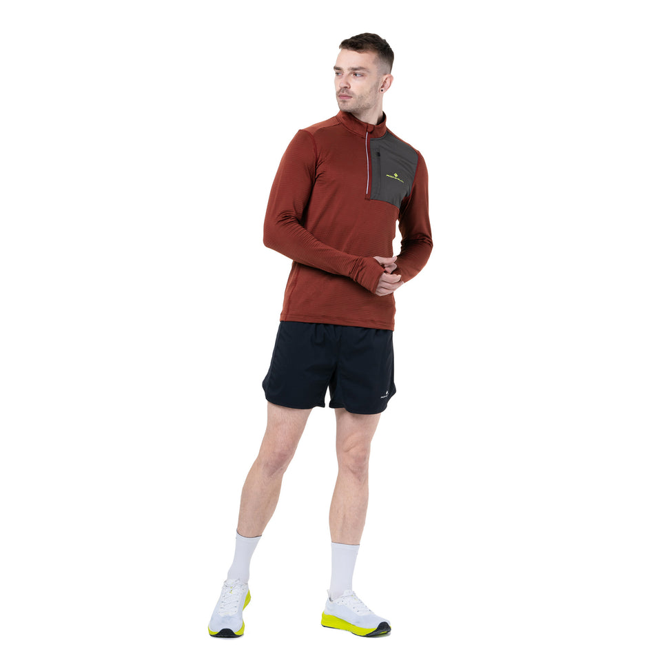 Front view of a model wearing the Ronhill Men's Tech Winter 1/2 Zip in the Chestnut/Oxide colourway. (8747100700834)