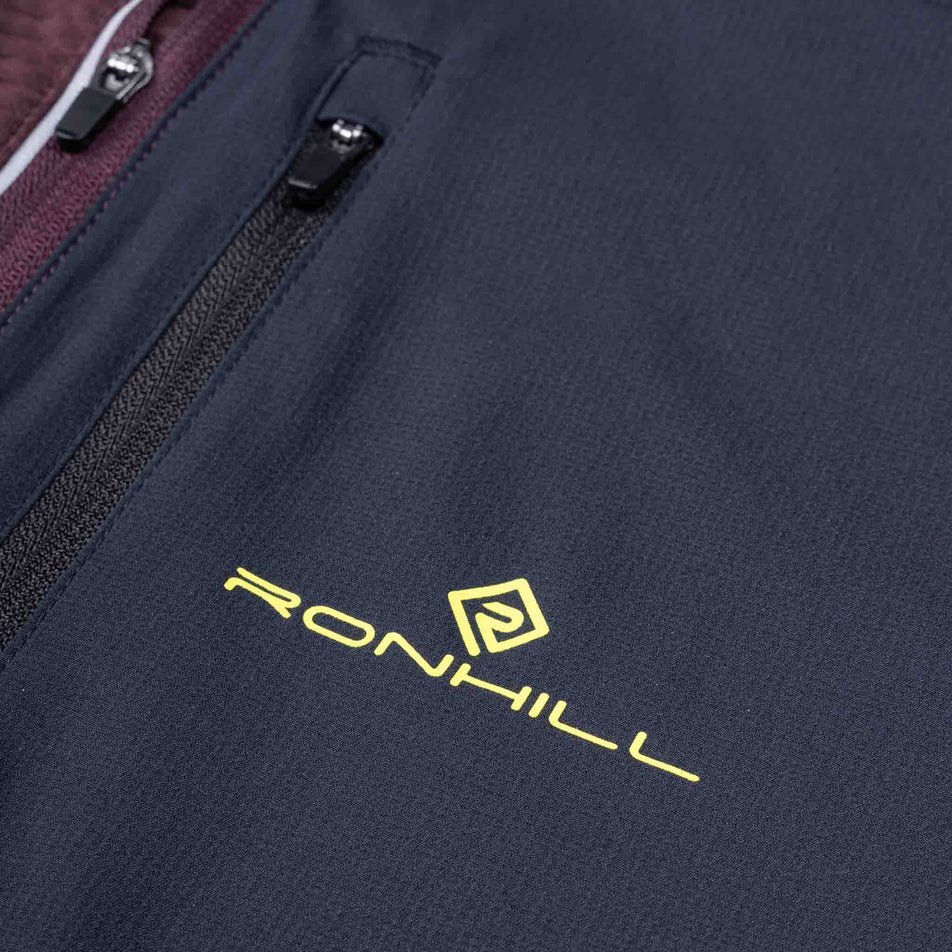 Close-up view of the chest pocket of the Ronhill Men's Tech Winter 1/2 Zip in the Espresso/Black colourway.