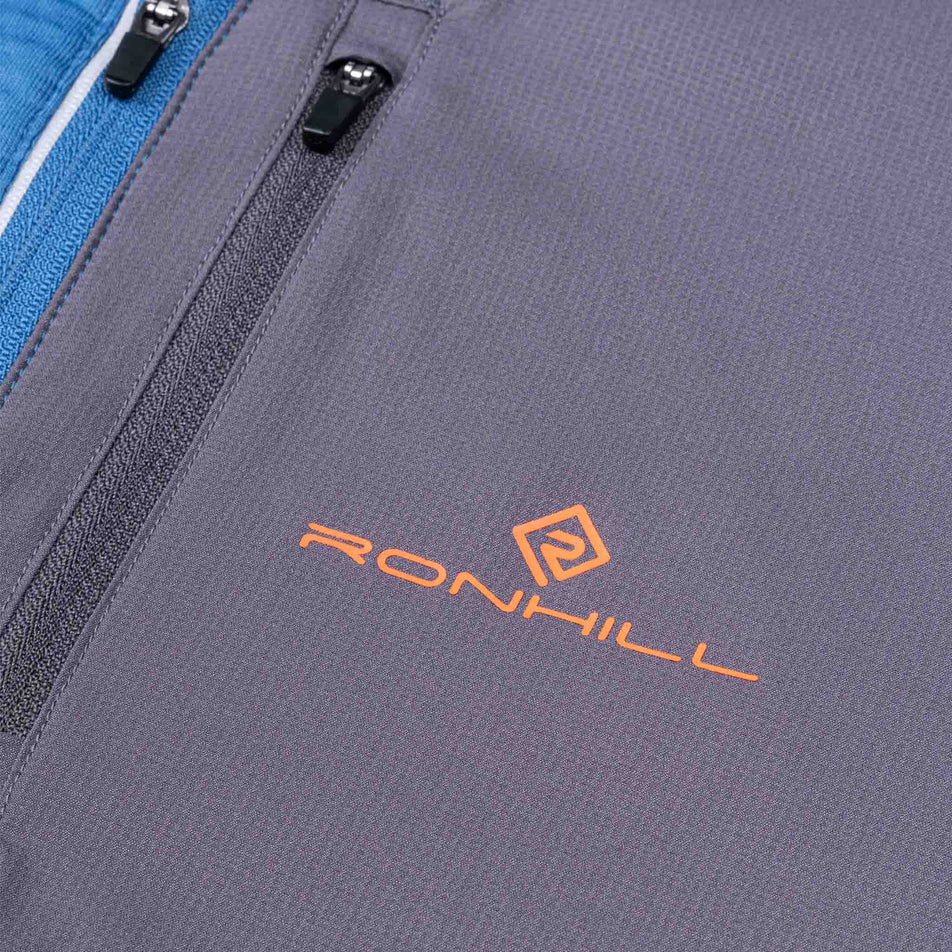 Close-up view of the chest pocket on the Ronhill Men's Tech Winter 1/2 Zip in the Glacier/Oxide colourway.