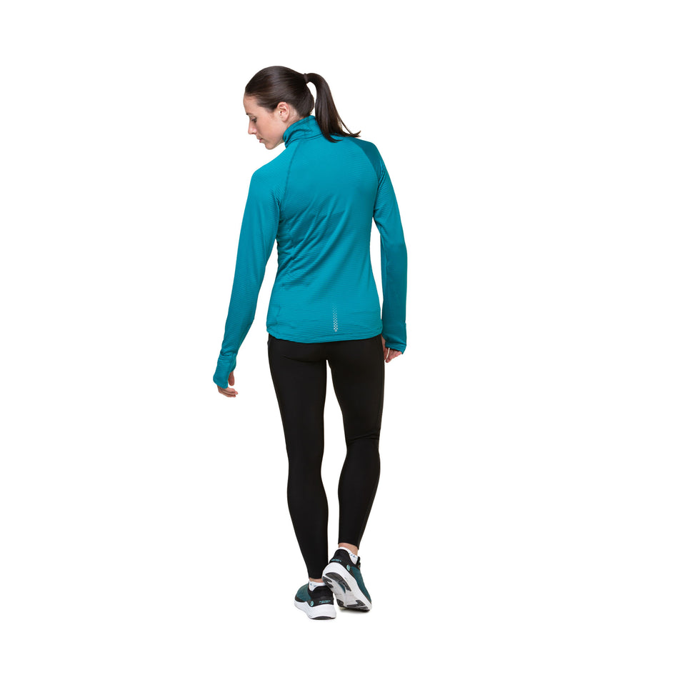 Back view of a model wearing a Ronhill Women's Tech Winter 1/2 Zip in the Marine/Acid colourway. Model is also wearing legging and shoes. (8489863348386)
