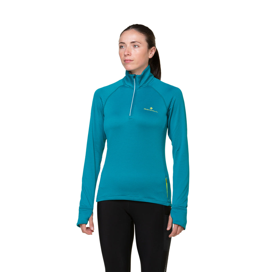 Front view of a model wearing a Ronhill Women's Tech Winter 1/2 Zip in the Marine/Acid colourway. Model is also wearing leggings. (8489863348386)
