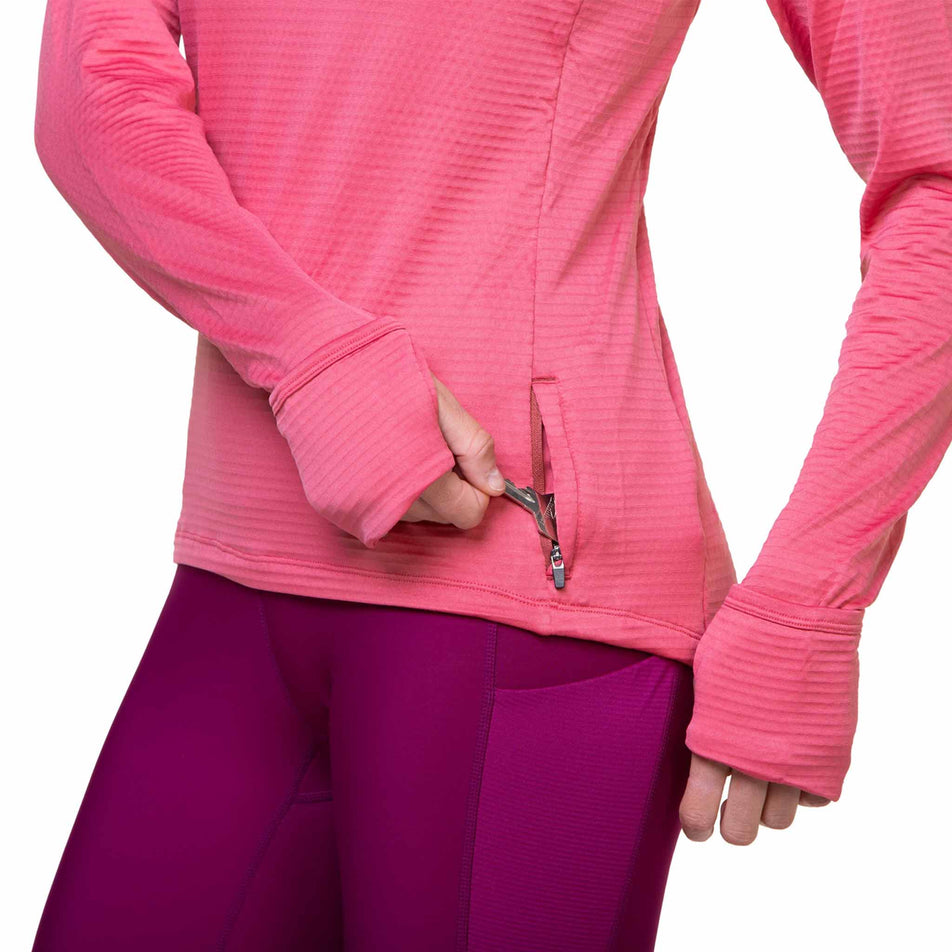 A model demonstrating that a key can be stored in the the Ronhill Women's Tech Winter 1/2 Zip's zip pocket. (8491142414498)