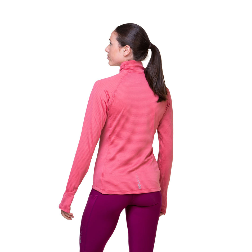 Back view of a model wearing the Ronhill Women's Tech Winter 1/2 Zip in the Salsa/Mango colourway. Model is also wearing leggings. (8491142414498)