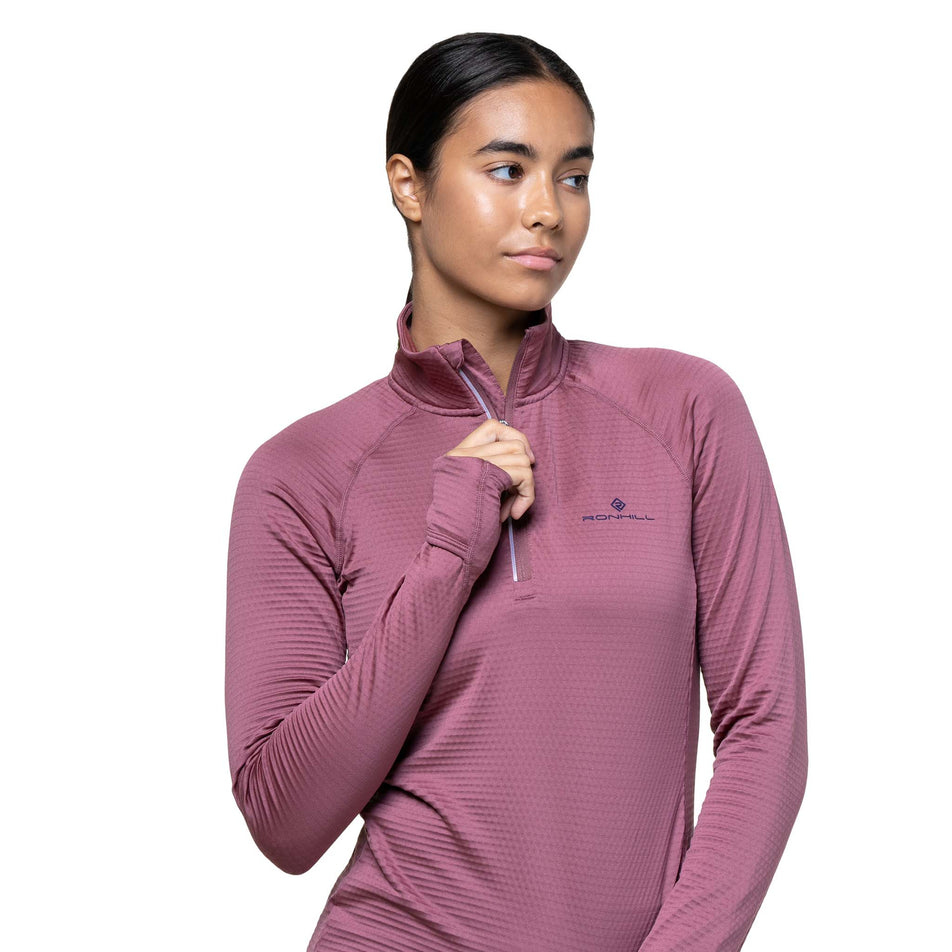 Front view of a model wearing the Ronhill Women's Tech Winter 1/2 Zip in the Dusty Tulip/Dark Navy colourway. (8747552211106)
