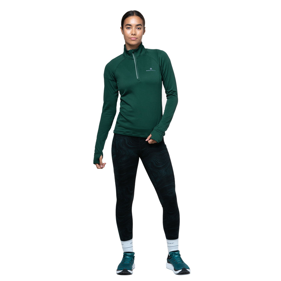 Front view of a model wearing the Ronhill Women's Tech Winter 1/2 Zip in the Seaweed/Iris colourway. (8747564925090)