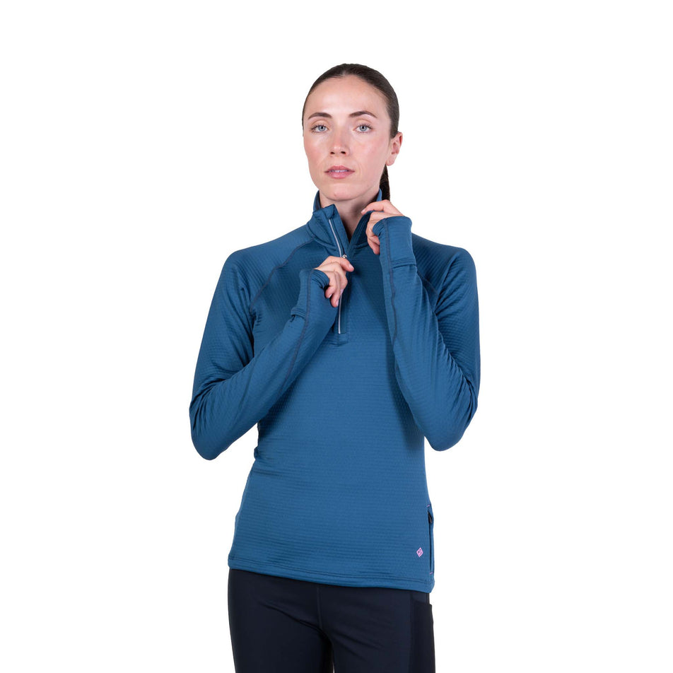 Front view of a model wearing the Ronhill Women's Tech Winter 1/2 Zip in the Legion Blue/Orchid colourway.