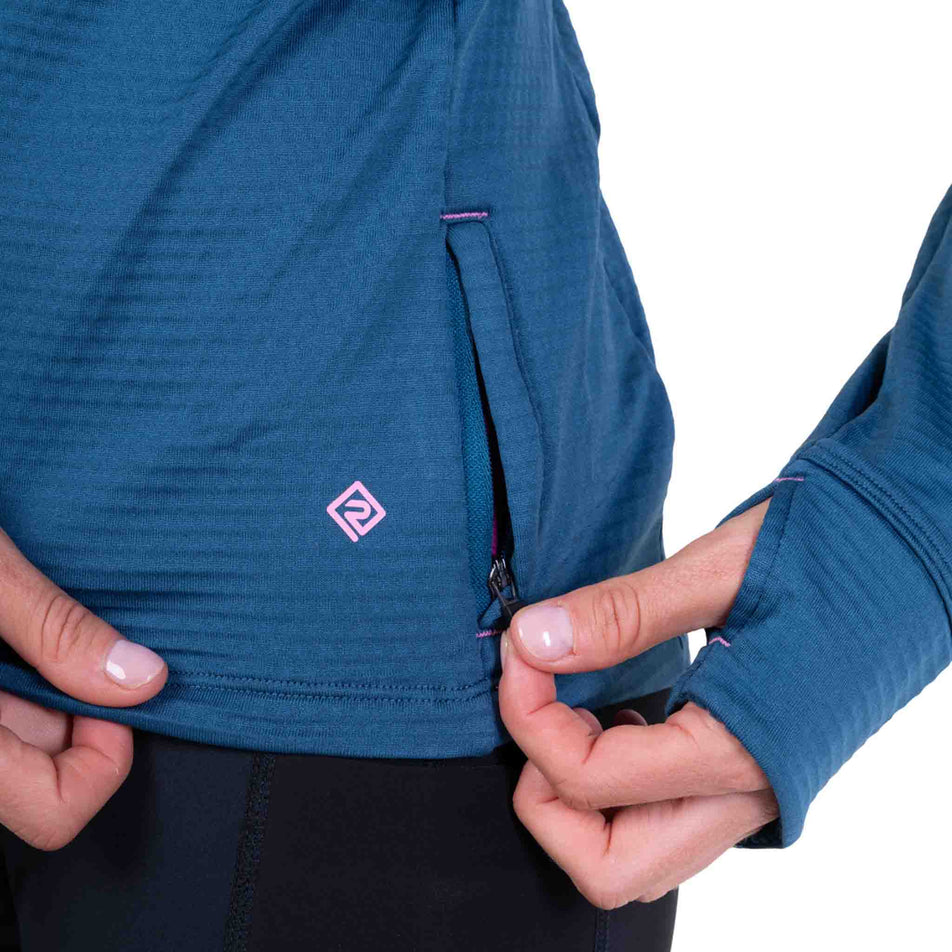 Close-up view of the zip pocket on the Ronhill Women's Tech Winter 1/2 Zip in the Legion Blue/Orchid colourway.
