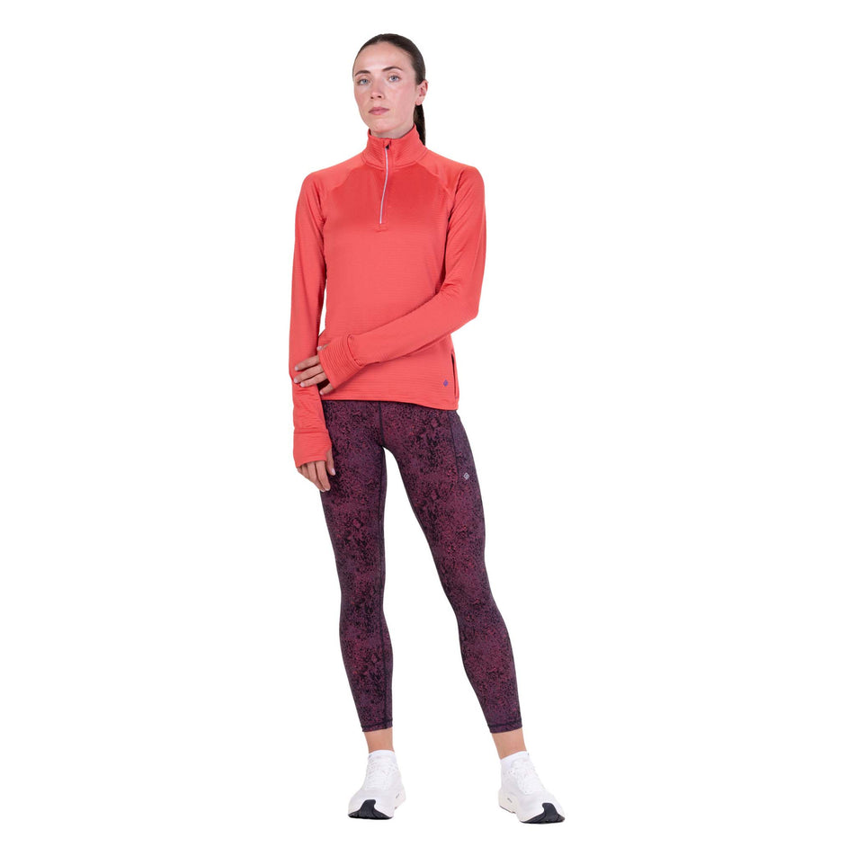 Front view of a model wearing the Ronhill Women's Tech Winter 1/2 Zip in the Sumac/Blue Violet colourway.