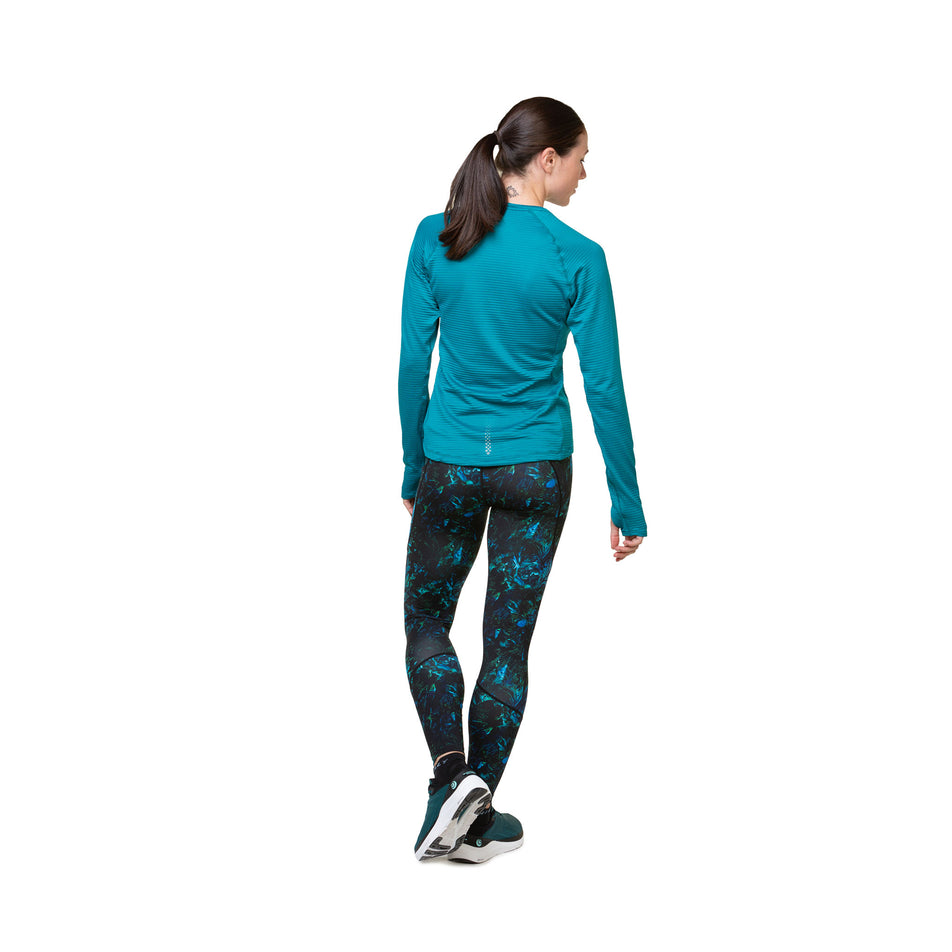 Back view of a model wearing a Ronhill Women's Tech Winter Crew in the Marine/Acid colourway. Model is also wearing leggings and shoes. (8489875177634)