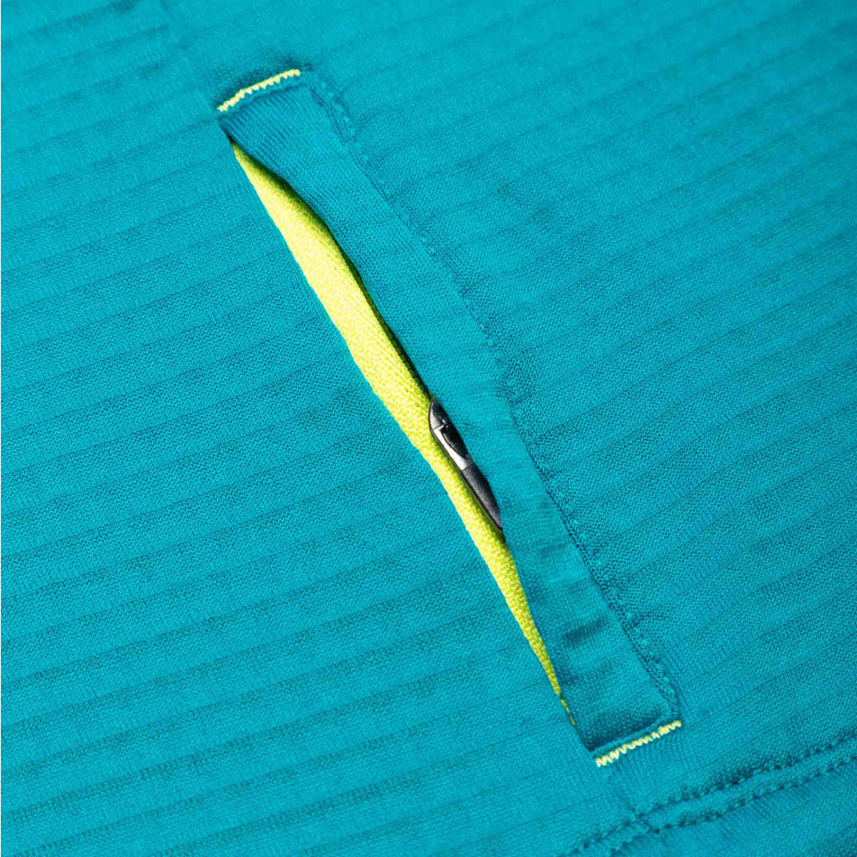 Close-up view of the zip pocket on a Ronhill Women's Tech Winter Crew in the Marine/Acid colourway. (8489875177634)