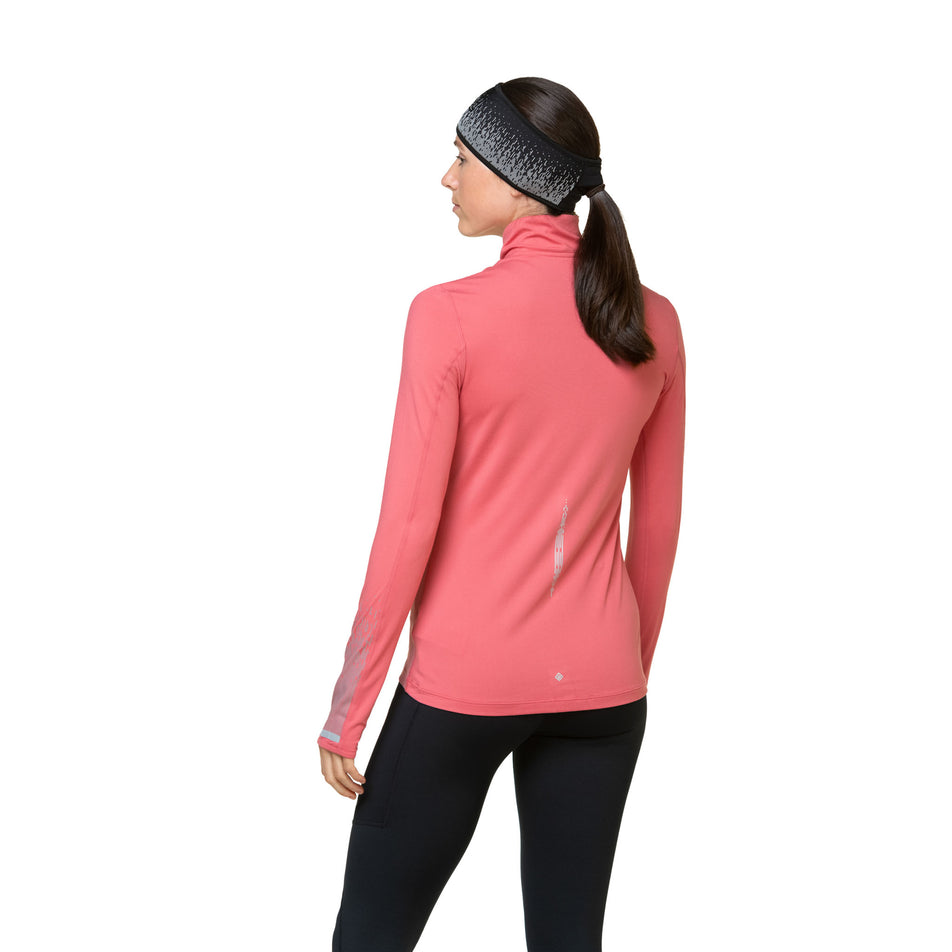 Back view of a model wearing a Ronhill Women's Tech Reflect 1/2 Zip in the Salsa/Reflect colourway. Model is also wearing leggings and a headband. (8469213249698)