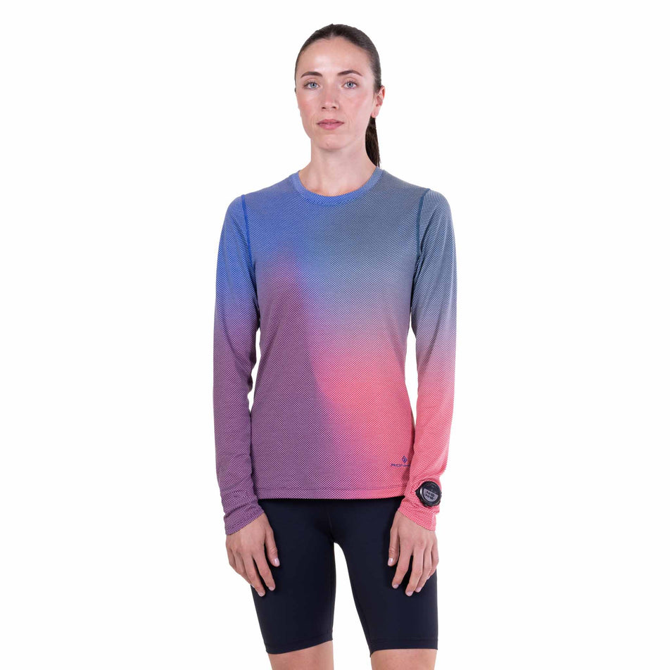 Front view of a model wearing the Ronhill Women's Tech Golden Hour L/S Tee in the Blue Violet Merge colourway.