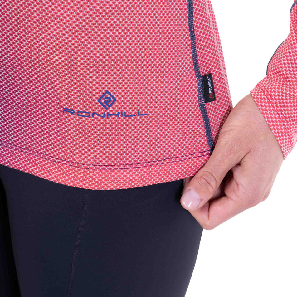 Close-up view of the Ronhill logo on the Ronhill Women's Tech Golden Hour L/S Tee in the Blue Violet Merge colourway.