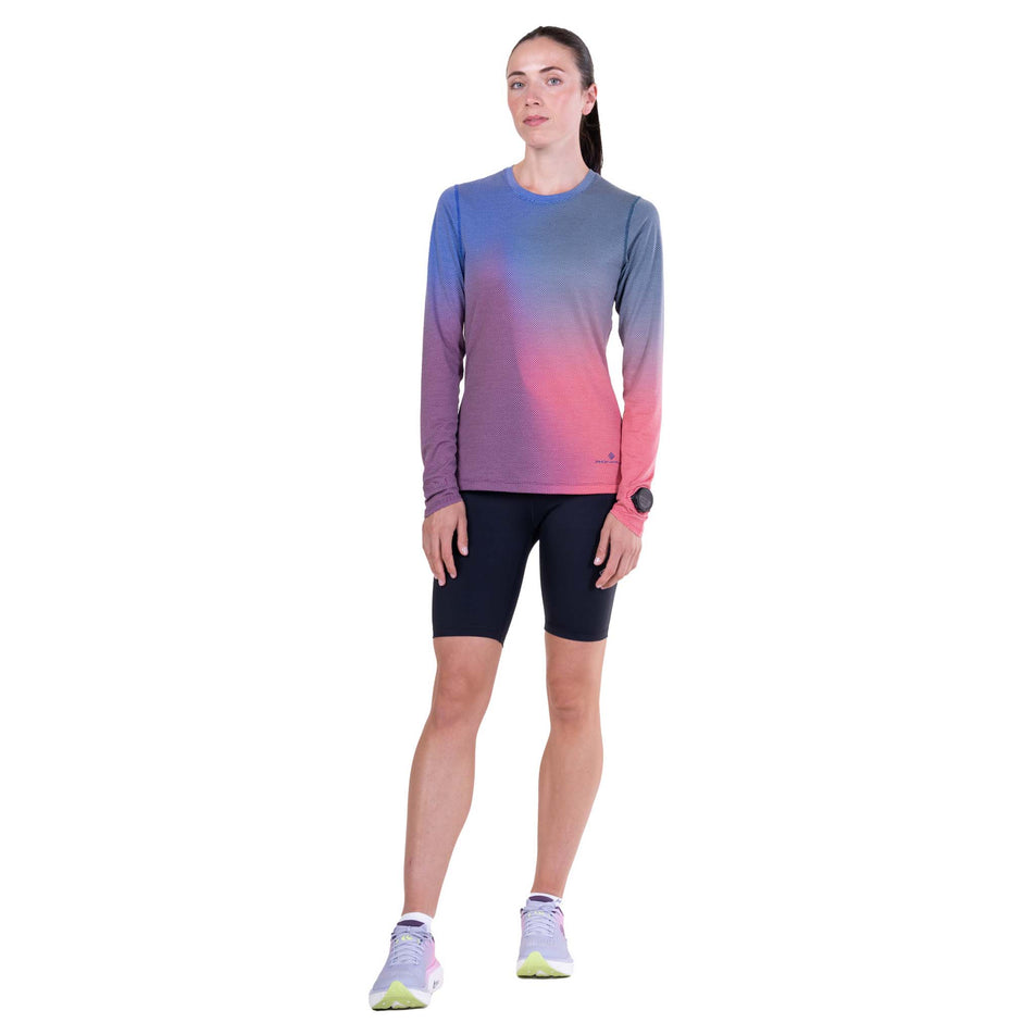 Front view of a model wearing the Ronhill Women's Tech Golden Hour L/S Tee in the Blue Violet Merge colourway.