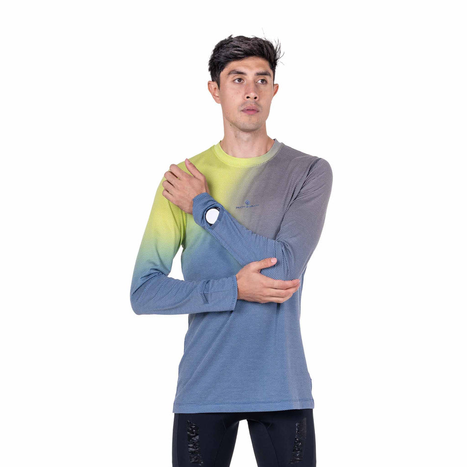 Front view of a model wearing the Ronhill Men's Tech Golden Hour L/S Tee in the Glacier Merge colourway.