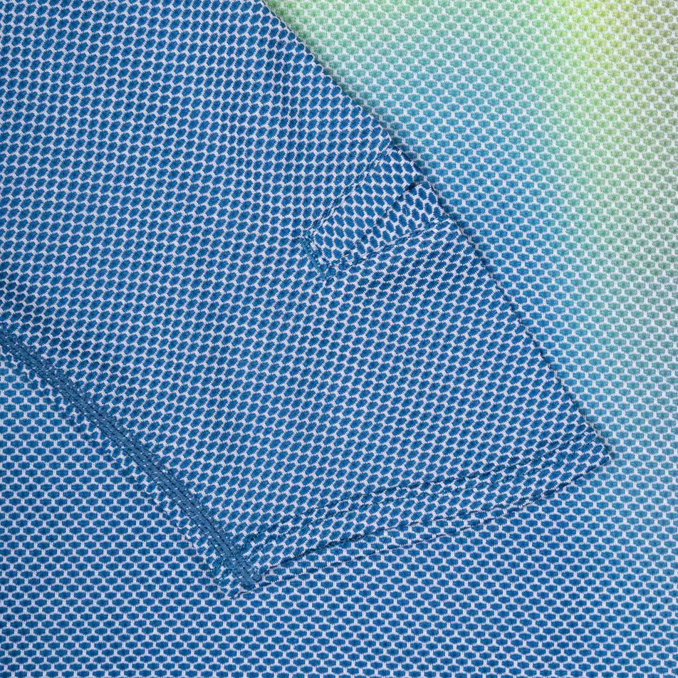 Close-up view of the sleeve of the Ronhill Men's Tech Golden Hour L/S Tee in the Glacier Merge colourway.