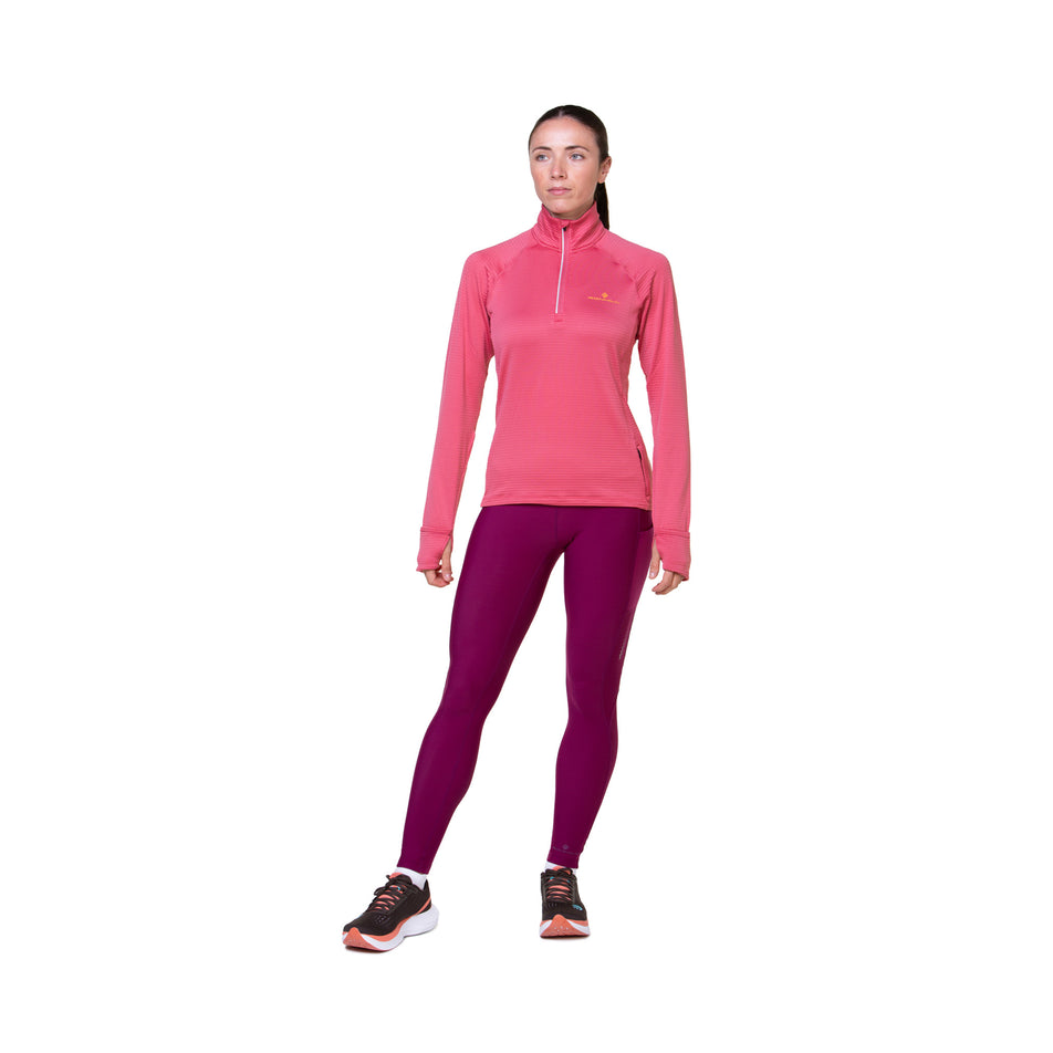 Front view of a model wearing the Ronhill Women's Tech Winter Tight in the Dark Blackcurrant colourway. Model is also wearing a top and shoes. (8489915777186)