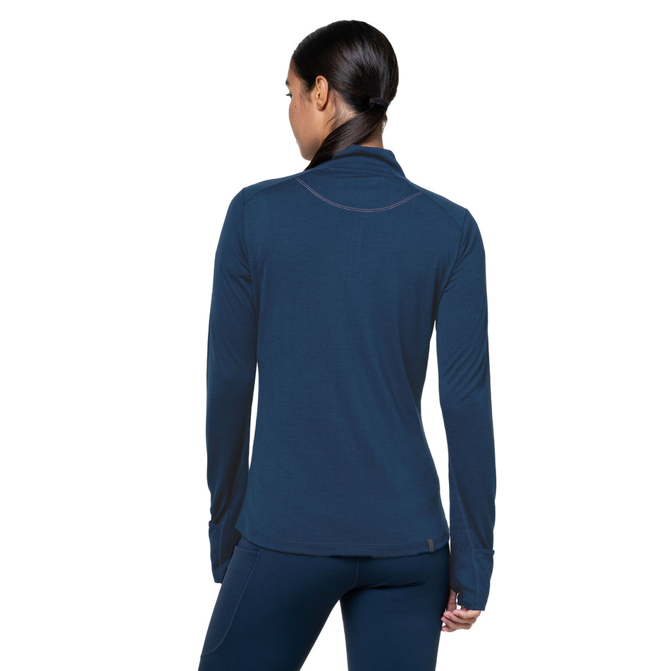 Back view of a model wearing the Ronhill Women's Tech Merino 1/2 Zip in the Dark Navy/Dusty Tulip colourway. (8742204997794)
