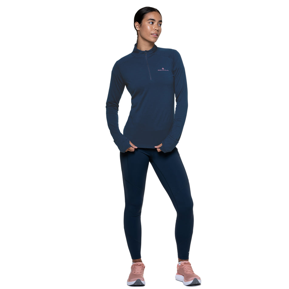 Front view of a model wearing the Ronhill Women's Tech Merino 1/2 Zip in the Dark Navy/Dusty Tulip colourway. (8742204997794)