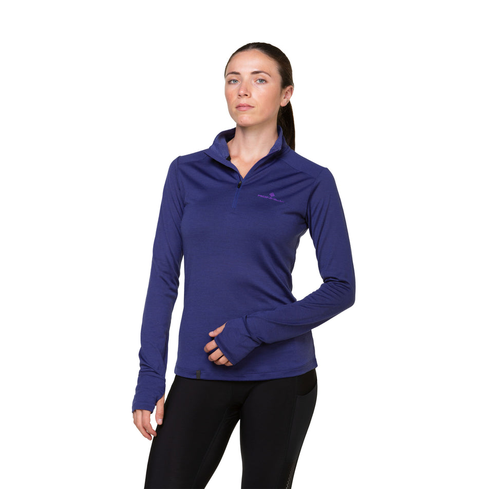 Front view of a model wearing the Ronhill Women's Tech Merino 1/2 Zip in the Deep Ocean/Regal Purple colourway. Model is also wearing leggings.  (8489925181602)