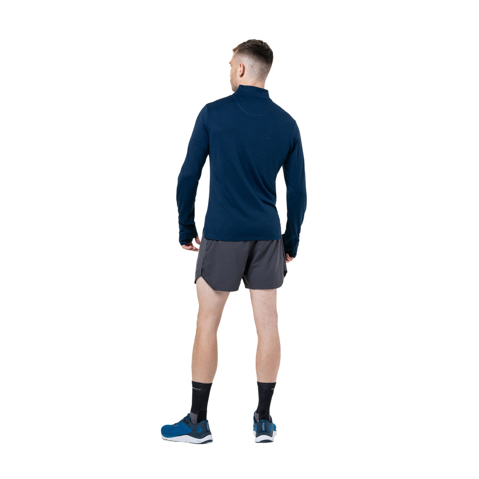 Back view a model wearing the Ronhill Men's Tech Merino 1/2 Zip in the Dark Navy/Oxide colourway. (8742863732898)