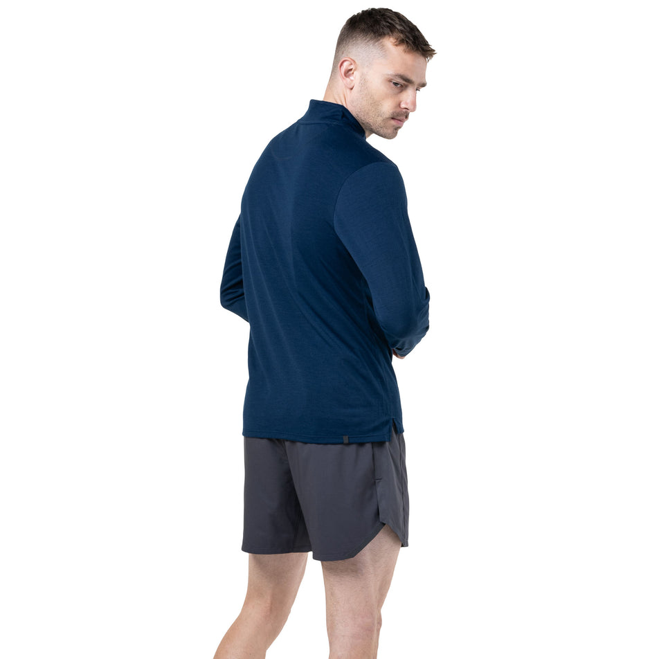 Back view a model wearing the Ronhill Men's Tech Merino 1/2 Zip in the Dark Navy/Oxide colourway. (8742863732898)