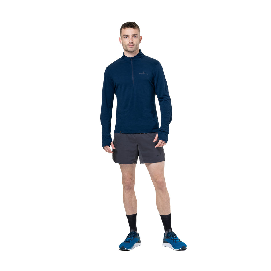 Front view a model wearing the Ronhill Men's Tech Merino 1/2 Zip in the Dark Navy/Oxide colourway. (8742863732898)