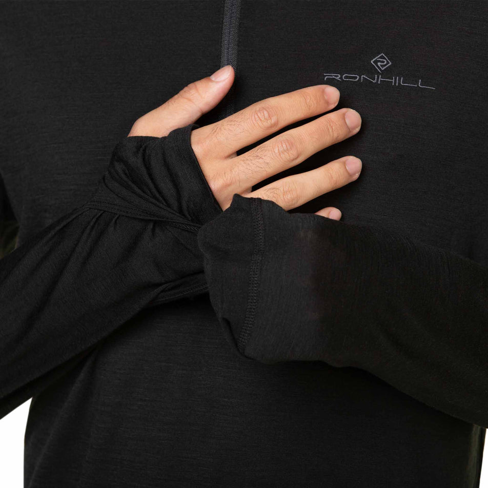 A model demonstrating the integrated mittens and hand covers on a Ronhill Men's Tech Merino 1/2 Zip. The top is being worn by the model. (8490269573282)