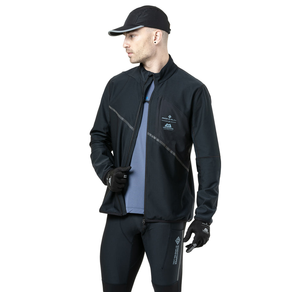 Front view of a model wearing the Ronhill Men's Tech GORE-TEX Windstopper Jacket in the All Black colourway. (8782555185314)