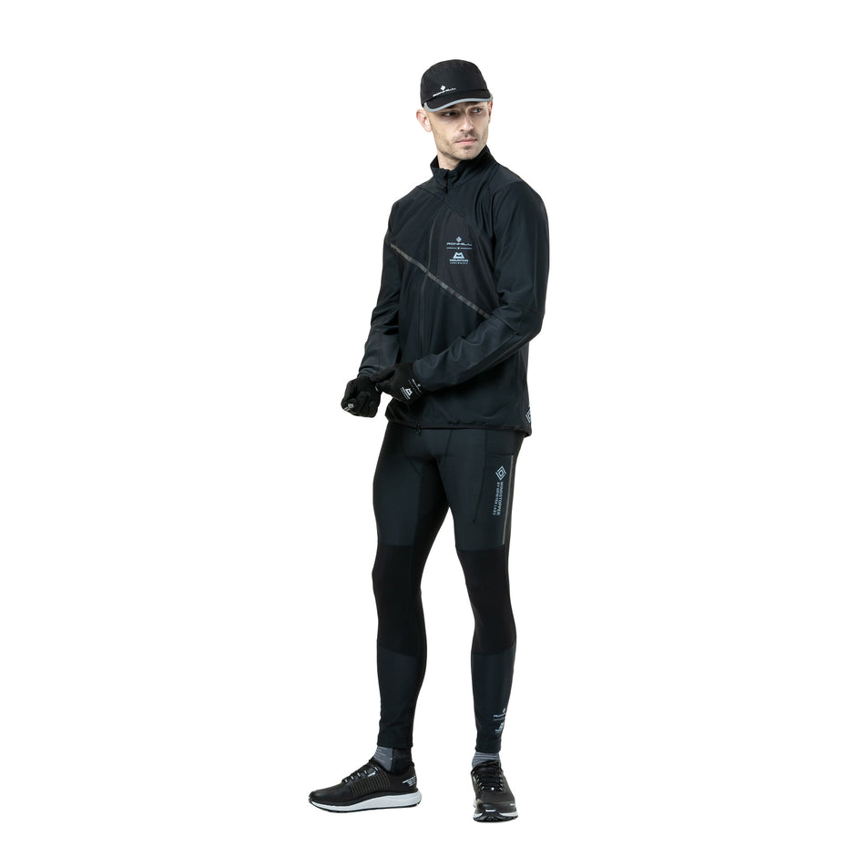 Front view of a model wearing the Ronhill Men's Tech GORE-TEX Windstopper Jacket in the All Black colourway. (8782555185314)