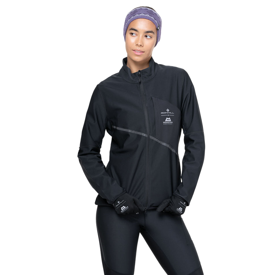 Front view of a model wearing the Ronhill Women's Tech GORE-TEX Windstopper Jacket in the All Black colourway. (8742206898338)