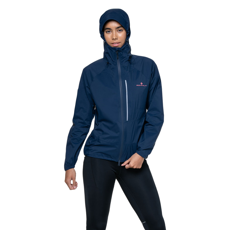Front view of a model wearing the Ronhill Women's Tech Storm Jacket in the Dark Navy colourway. (8742197559458)