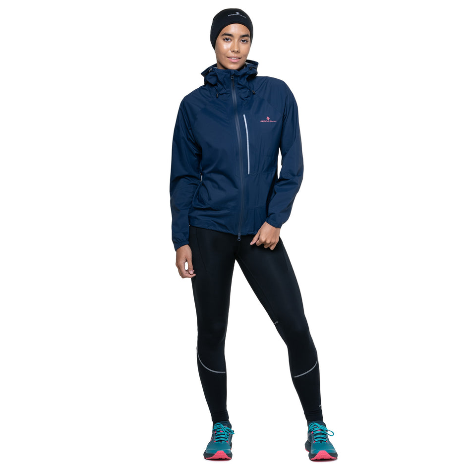 Front view of a model wearing the Ronhill Women's Tech Storm Jacket in the Dark Navy colourway. (8742197559458)