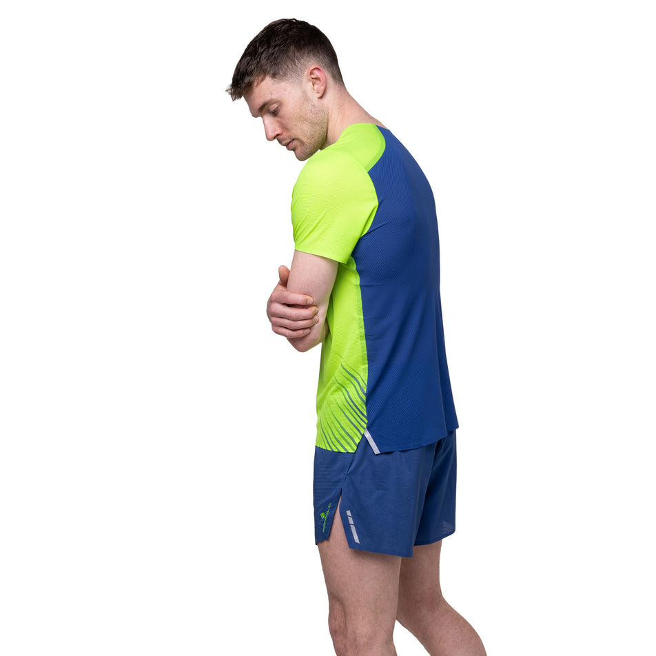 Angled view of a model wearing the Ronhill Men's Tech Race 5