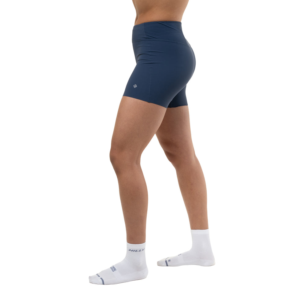 Side view of a model wearing the Ronhill Women's Tech Race Stretch Short in the Evening Haze colourway.