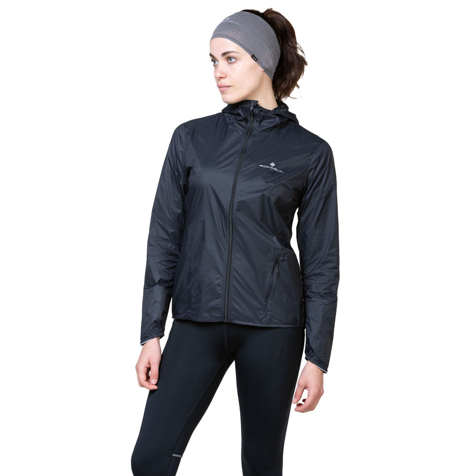 Front view of a model wearing the Ronhill Women's Tech All-Terrain Jacket in the All Black colourway. (8563593511074)