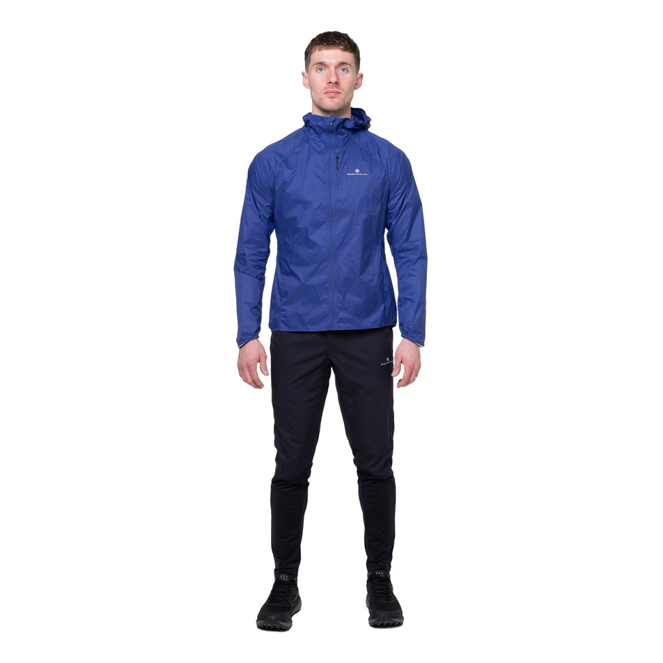 Front view of a model wearing the Ronhill Men's Tech All-Terrain Jacket in the Dark Cobalt colourway.