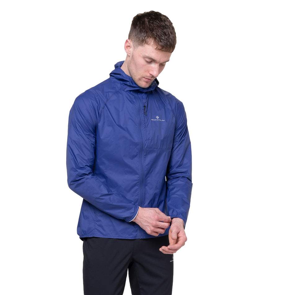 Front view of a model wearing the Ronhill Men's Tech All-Terrain Jacket in the Dark Cobalt colourway.